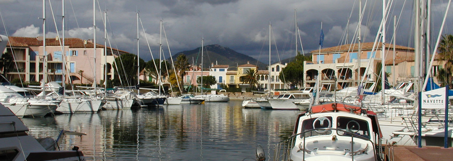 Cogolin's town harbor with boats and buildings