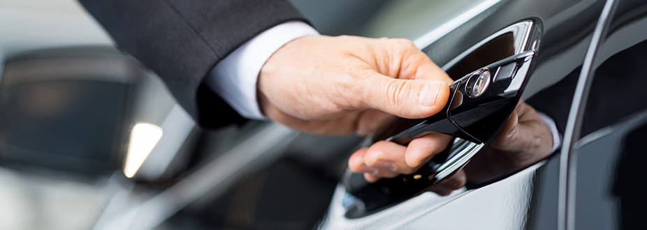 Private Chauffeur opening the door of a limousine